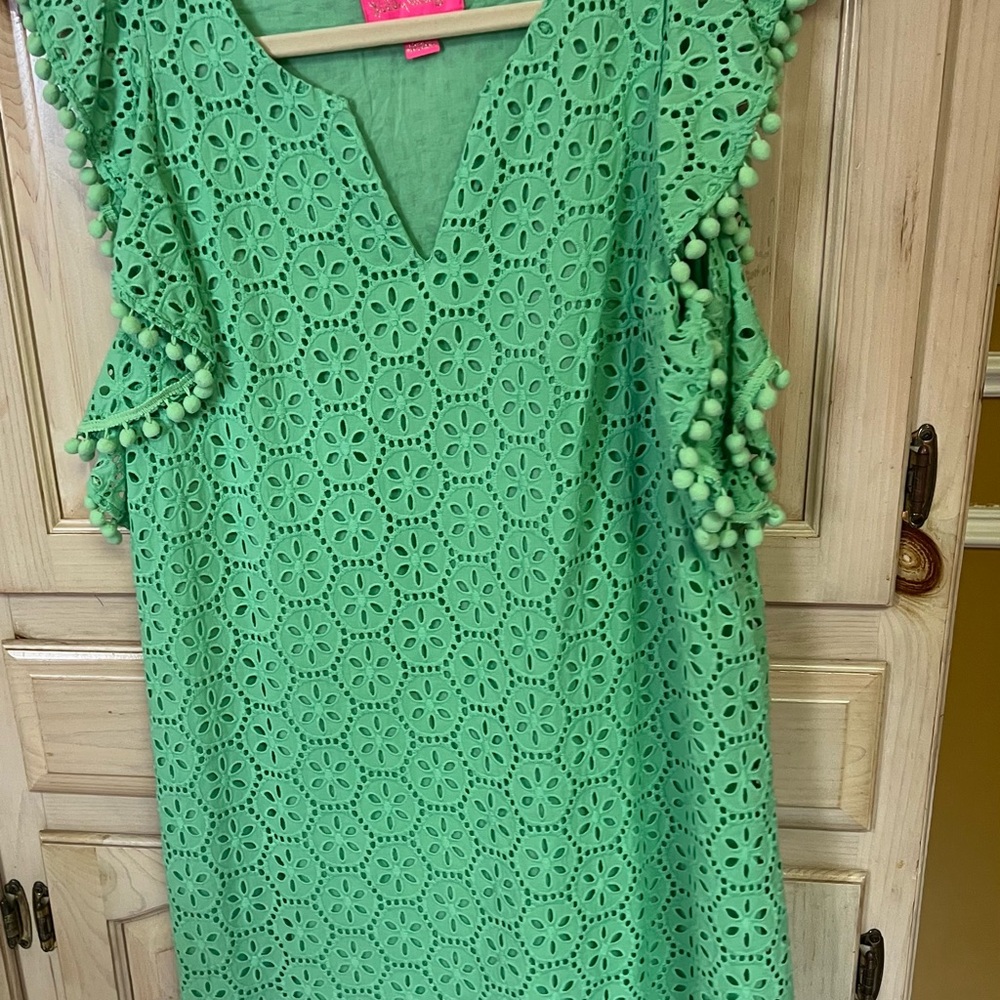 Lilly Pulitzer A line dress with pattern cut outs adorned with pompoms.